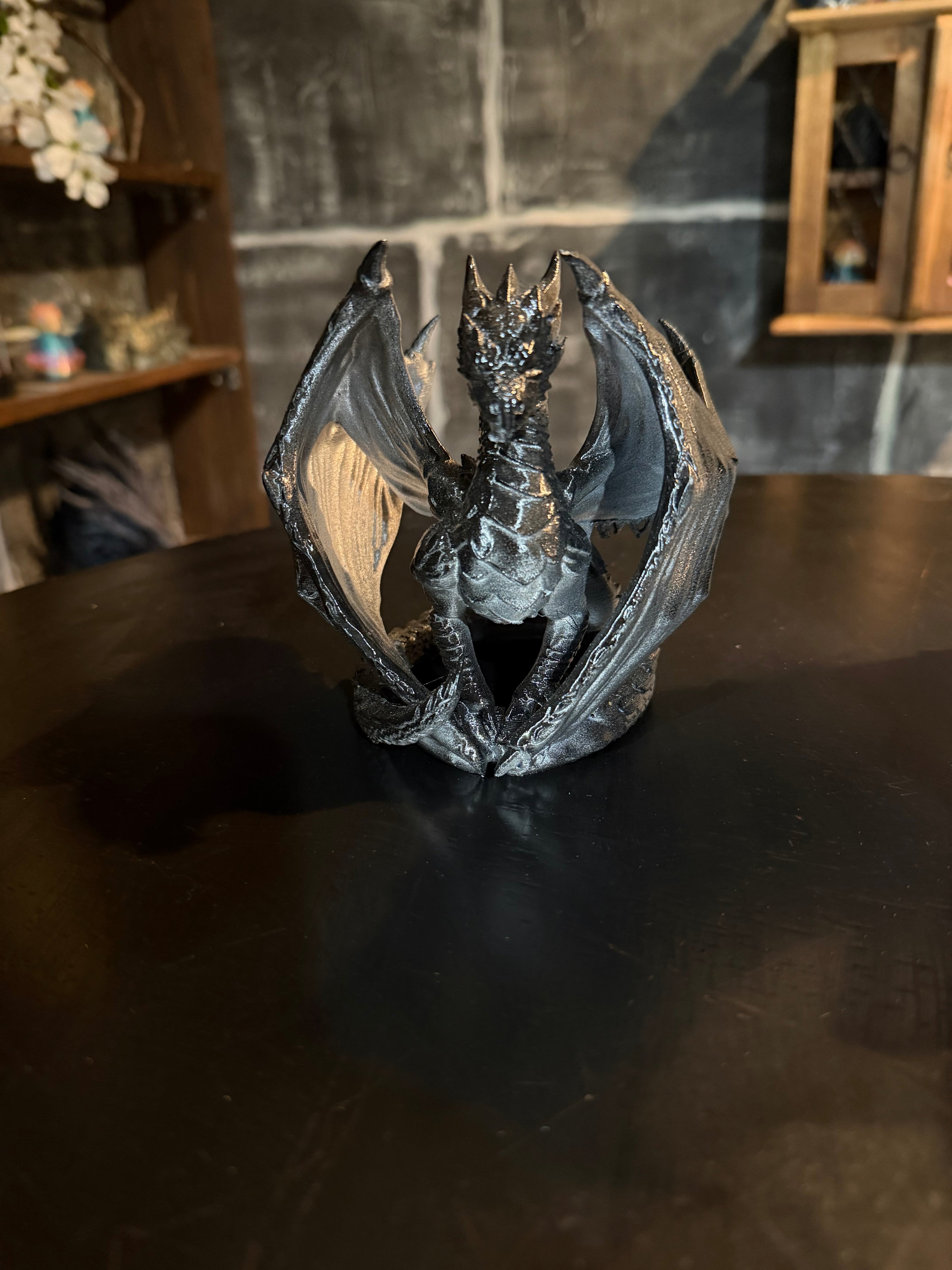 Nightfall Dragon seated pose showing spread wings and deep black metallic finish